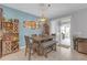 Dining area with a modern table set, built-in bar, and sliding glass doors leading to the patio at 11684 Brighton Knoll Loop, Riverview, FL 33579