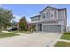 Charming two-story home featuring a gray exterior, well-maintained lawn, and a spacious driveway at 11684 Brighton Knoll Loop, Riverview, FL 33579