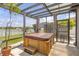 Inviting hot tub in a screened enclosure with a view of the surrounding landscape at 11684 Brighton Knoll Loop, Riverview, FL 33579