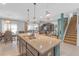 Open-concept kitchen and living area featuring an island with breakfast bar, and an adjacent dining space at 11684 Brighton Knoll Loop, Riverview, FL 33579