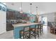 Stylish kitchen with a large island, granite countertops, dark cabinets, and stainless steel appliances at 11684 Brighton Knoll Loop, Riverview, FL 33579