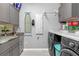 Well-organized laundry room with gray cabinets, marble countertops, and modern washer and dryer at 11684 Brighton Knoll Loop, Riverview, FL 33579