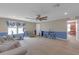 Bright living room showcasing workout equipment, a ceiling fan, neutral walls, and easy access to other spaces at 11684 Brighton Knoll Loop, Riverview, FL 33579