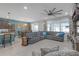 Open-concept living and dining area with a gray sectional sofa and stylish decor at 11684 Brighton Knoll Loop, Riverview, FL 33579
