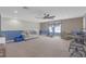 Inviting living room with comfortable seating, exercise equipment, and soft natural light at 11684 Brighton Knoll Loop, Riverview, FL 33579