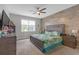Cozy primary bedroom with wood accent wall and comfortable furnishings at 11684 Brighton Knoll Loop, Riverview, FL 33579