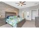 View of a bedroom with a wood accent wall, and ceiling fan at 11684 Brighton Knoll Loop, Riverview, FL 33579