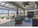 Relaxing screened patio with comfortable seating, ceiling fan, and view of backyard at 11684 Brighton Knoll Loop, Riverview, FL 33579
