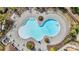 Aerial view of a community pool with lounge chairs and lush landscaping, creating a resort-like atmosphere at 11684 Brighton Knoll Loop, Riverview, FL 33579
