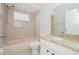 Cozy bathroom showcasing a granite countertop, bathtub, and window at 11741 Teapot Ct, Spring Hill, FL 34609