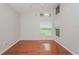 Bright bedroom featuring hardwood floors, neutral walls, and sun-filled windows at 11741 Teapot Ct, Spring Hill, FL 34609