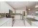Modern kitchen featuring white cabinetry, stainless steel appliances, and designer backsplash at 11741 Teapot Ct, Spring Hill, FL 34609