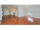 Bright living room featuring gleaming hardwood floors and a kitchen view at 11741 Teapot Ct, Spring Hill, FL 34609