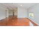 Bright living room featuring gleaming hardwood floors and a vaulted ceiling at 11741 Teapot Ct, Spring Hill, FL 34609