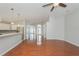 Bright living room featuring gleaming hardwood floors, a kitchen, and large windows at 11741 Teapot Ct, Spring Hill, FL 34609