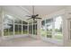 Bright sunroom with tile flooring, fan and multiple glass windows with backyard views at 11741 Teapot Ct, Spring Hill, FL 34609