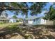 Spacious backyard with a tree, swing, a shed, and a patio at 12019 106Th Ct, Largo, FL 33778