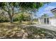 Spacious backyard with large tree, swing, firepit, and shed at 12019 106Th Ct, Largo, FL 33778