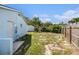Side view of the backyard with a shed, partial fence, and sparse grass at 12019 106Th Ct, Largo, FL 33778