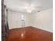 Spacious bedroom featuring hardwood floors, ceiling fan, and access to an en-suite bathroom at 12019 106Th Ct, Largo, FL 33778
