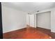 Bright bedroom featuring hardwood floors, neutral walls, closet, and doorway to hall at 12019 106Th Ct, Largo, FL 33778
