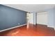 Spacious bedroom with hardwood floors, blue accent wall, and a large closet space at 12019 106Th Ct, Largo, FL 33778