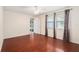 Bright bedroom featuring hardwood floors, neutral walls, and windows with elegant curtains at 12019 106Th Ct, Largo, FL 33778