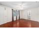 Large bedroom featuring hardwood floors, ceiling fan, and an en-suite bathroom at 12019 106Th Ct, Largo, FL 33778