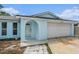 Inviting front entrance with an arched entryway, concrete walkway and a two-car garage at 12019 106Th Ct, Largo, FL 33778