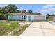 Charming single-Gathering home featuring a two-car garage, a light blue exterior, and a well-maintained front yard at 12019 106Th Ct, Largo, FL 33778