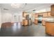 Open-concept kitchen with stainless steel appliances and wooden cabinetry, seamlessly connected to the living area at 12019 106Th Ct, Largo, FL 33778