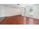 Bright living room with pristine hardwood floors, neutral walls, and natural light from the windows at 12019 106Th Ct, Largo, FL 33778