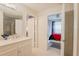 Bright bathroom with modern vanity and a view into the adjacent bedroom at 1230 S Missouri Ave # 704, Clearwater, FL 33756