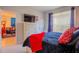 Comfortable bedroom featuring nautical decor and a glimpse into the living room at 1230 S Missouri Ave # 704, Clearwater, FL 33756