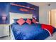 Cozy bedroom with nautical-themed decor and pops of red color at 1230 S Missouri Ave # 704, Clearwater, FL 33756