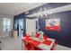 Charming dining area featuring a modern chandelier and red chairs for a striking contrast at 1230 S Missouri Ave # 704, Clearwater, FL 33756