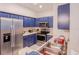 Modern kitchen with stainless steel appliances and bright blue cabinetry at 1230 S Missouri Ave # 704, Clearwater, FL 33756