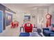 Open-concept living and dining area with nautical-themed decor and bright red accents at 1230 S Missouri Ave # 704, Clearwater, FL 33756