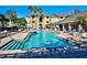 Community swimming pool with lounge chairs and lush landscaping at 1230 S Missouri Ave # 704, Clearwater, FL 33756