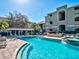 Sparkling community pool featuring a charming pergola and comfortable lounge seating at 1230 S Missouri Ave # 704, Clearwater, FL 33756