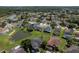 Expansive aerial view of a residential community with lush landscaping, serene lakes, and well-maintained homes at 1246 Ocean Reef Rd, Wesley Chapel, FL 33544