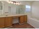 A large bathroom featuring a double vanity, bathtub, and a glass-enclosed shower at 1246 Ocean Reef Rd, Wesley Chapel, FL 33544