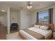 A bright bedroom featuring neutral tones, plush rug, and a large window at 1246 Ocean Reef Rd, Wesley Chapel, FL 33544