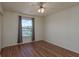 A cozy bedroom with wood floors and a large window that offers a view of the outdoors at 1246 Ocean Reef Rd, Wesley Chapel, FL 33544