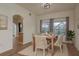 Cozy dining area with hardwood floors, stylish lighting, and views of the lanai at 1246 Ocean Reef Rd, Wesley Chapel, FL 33544