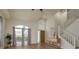Sun-filled entryway features high ceilings, hardwood floors, and a staircase leading upstairs at 1246 Ocean Reef Rd, Wesley Chapel, FL 33544