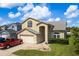 Charming two-story home boasts a two-car garage, landscaped yard, and inviting entryway at 1246 Ocean Reef Rd, Wesley Chapel, FL 33544