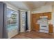 Bright kitchen nook with pool views, oak cabinets, and standard appliances create inviting space at 1246 Ocean Reef Rd, Wesley Chapel, FL 33544