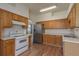 Functional kitchen features oak cabinets, stainless steel refrigerator, and ample counter space at 1246 Ocean Reef Rd, Wesley Chapel, FL 33544