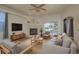 A bright living room with a fireplace, comfortable seating, and a sliding glass door at 1246 Ocean Reef Rd, Wesley Chapel, FL 33544